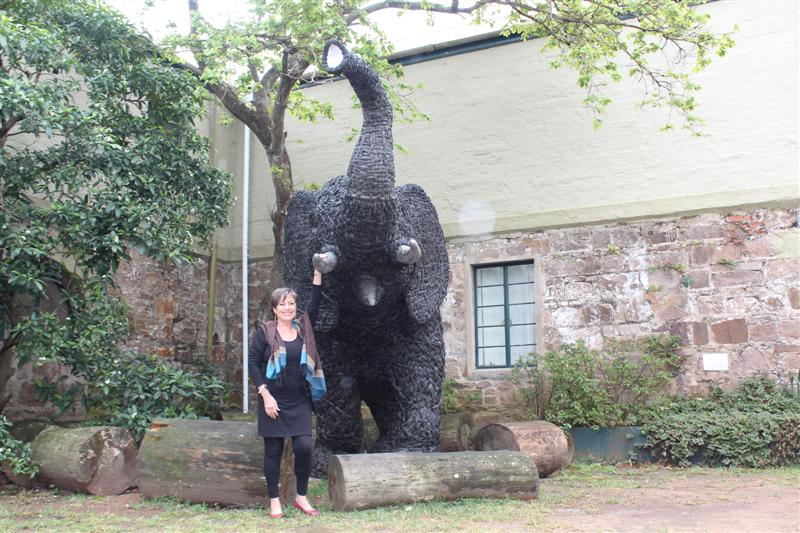 Resource development director of Wilderness Leadership School at Stainbank Nature Reserve, Cherrly Curry looks small is size compared to the life-size elephant sculpture, 'Nomkhubulwane', which is formed out of recycled truck tyres.