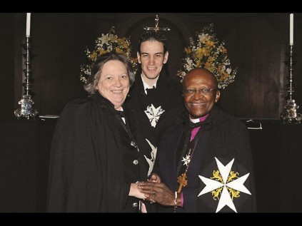 Catherine and her son, Rowan together with Bishop Tutu as she receives her award.