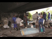 Residents of a squatter camp under Huletts bridge try to recover some of their goods after their shacks were demolished on Friday, 18 October.