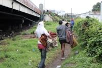 Squatters vacate the bridge with their belongings.