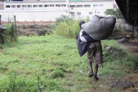A squatter leaving a camp under Huletts bridge.
