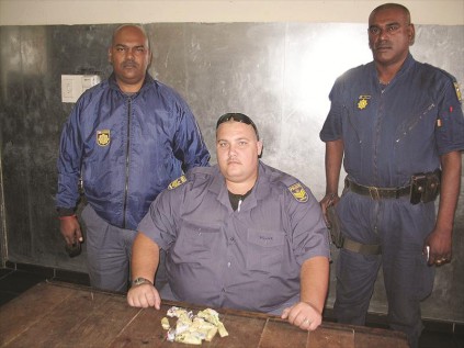 Warrant officer Sookdhaw and Sergeants Wilkens and Nair with the drugs seized in the Dinapur Road arrest.