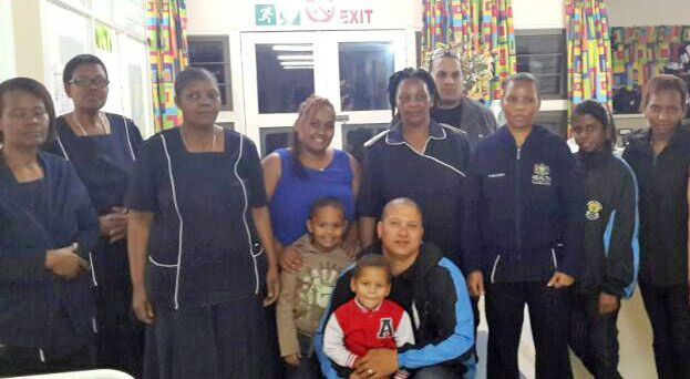 Sade` Lochenberg, Darian Smith, Neil Axford, Melissa Morgan and Asanda Majali with the staff of John Dunn Home in Wentworth.