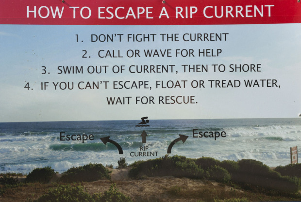 A sign at Swartvlei beach warns of the danger of rip currents.