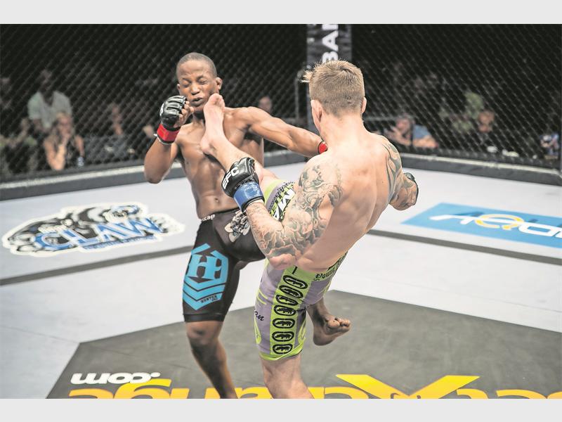 Wesley Hawkey lands a kick on Sizwe Mnikathi in bout nine of the EFC43 featherweight fight at Durban’s ICC arena on Friday, 27 August. Photo: Ruby Wolff / EFC Worldwide 2015.