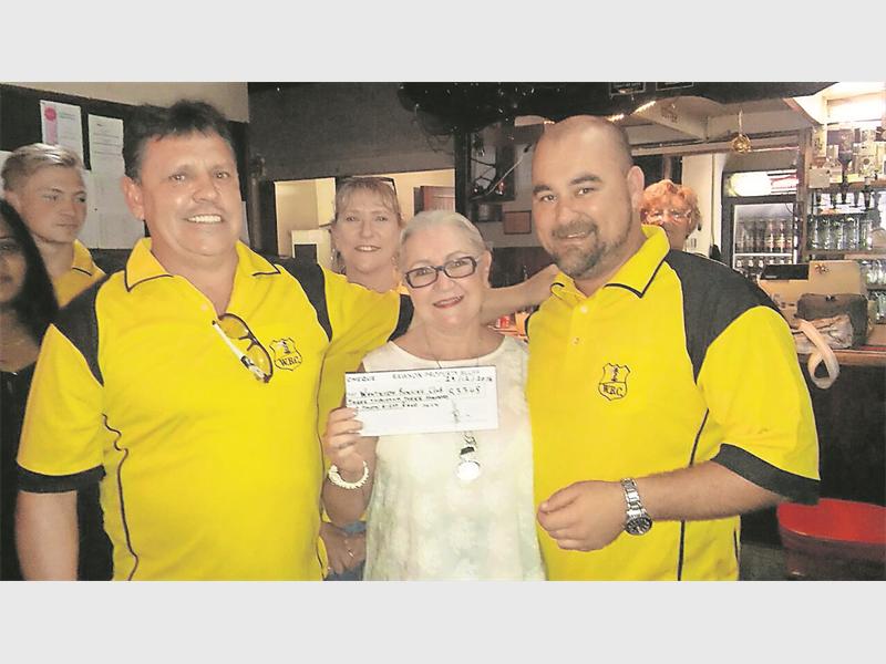 Mike Jansen and Pieter Barnard from Rawsons Properties present Ellen Loots with a cheque for the Wentworth Bowling Club.