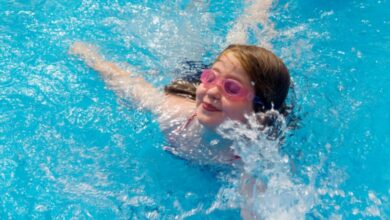 Young girl aged 9 to 12 years learning to swim