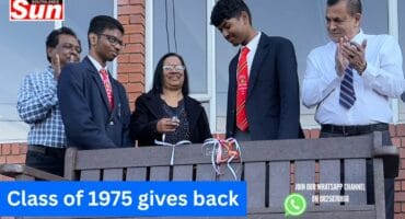 A wooden bench outside a school
