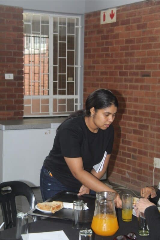 Sylke Marais serving the attendees from the community.