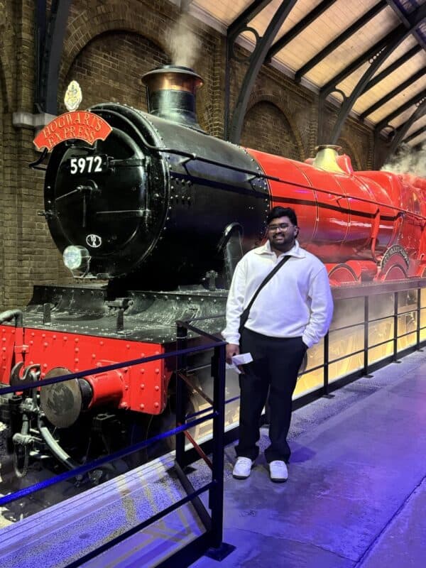 Dillon Pillay poses next to the Hogwarts Express.