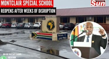 Cars in the parking lot of a school. A circle displaying a picture of the KZN premier Thamsanqa Ntuli.