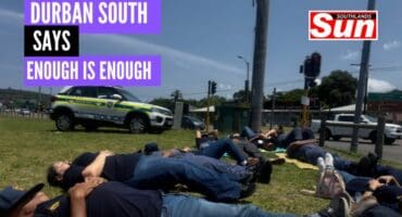 Community members lie down for 15 minutes outside Oxford on The Bluff.