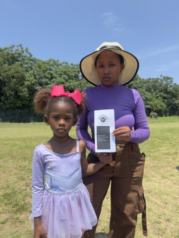 Lisakhanya Kwinana and her mother Esona Kwinana show their support by distributing pamphlets on The Bluff.