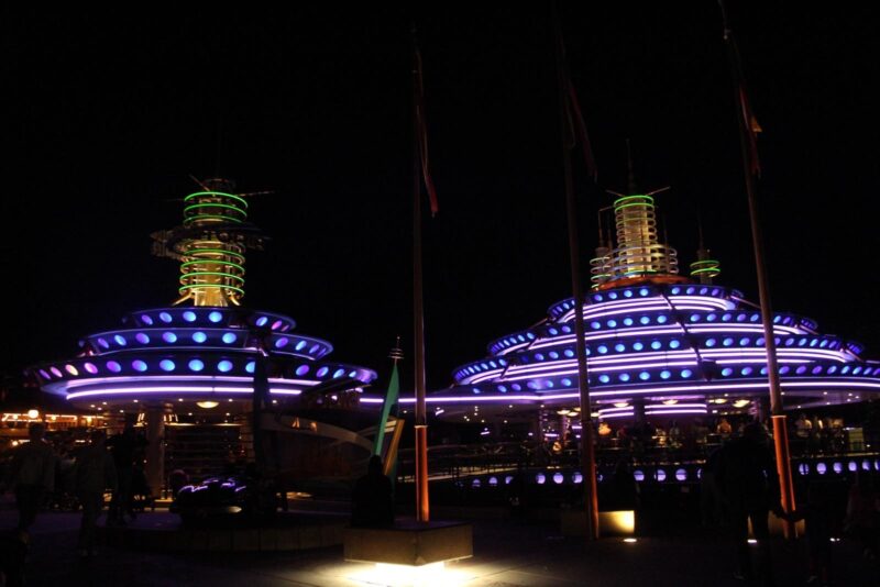 Two of the rides at night at Disneyland Paris.