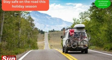 A fully packed vehicle driving on a road.