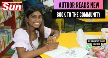 Ekta Somera with signs a copy of her new book, Lilly The Llama.