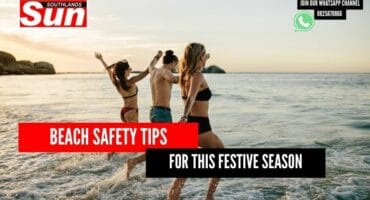 Three people frolicking in the waves