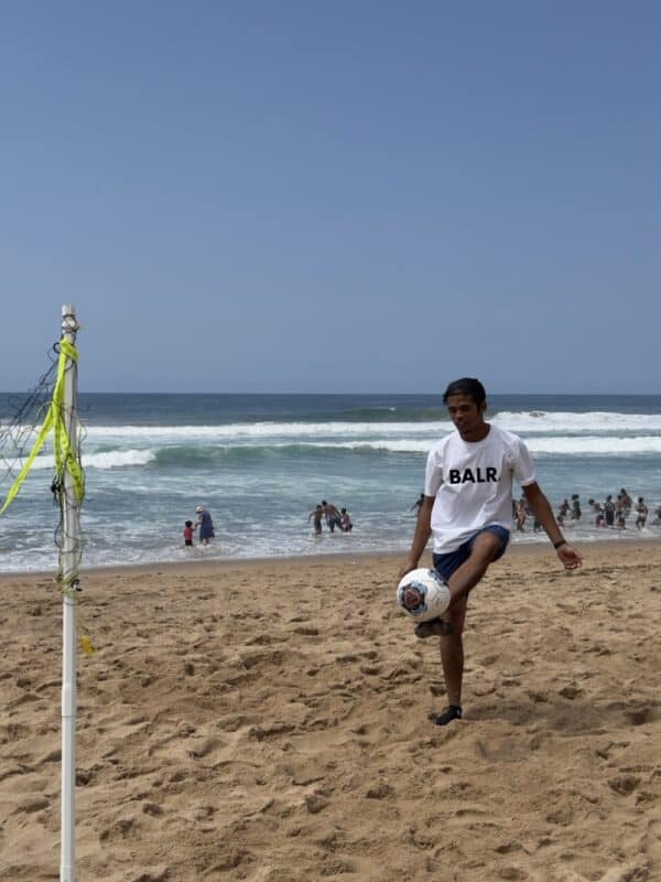 Mohammed Zaheer Alli plays a blend of volleyball and football on the beach.