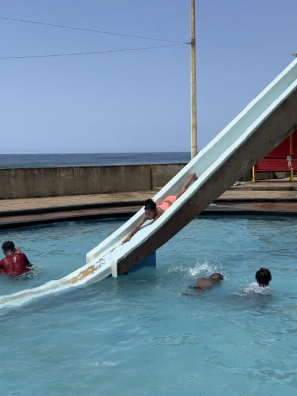 Zia Meyers goes head first as she slides at the Brighton Beach pool.