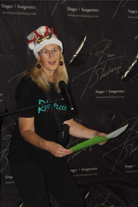 Robin Hood Foundation's Charlotte Edgar helps hand out Christmas gift's to the residents.