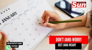 A person writing on a calendar.