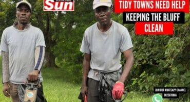 Dumisani Mantshule and Michael Maraule work together to clean up The Bluff.