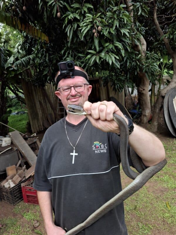 The Bluff snake catcher Warren Dick with the rescued black mamba. 