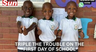 Triplets posing for their first day of school.