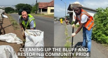 two people using spades and rubbish bags to clean up on a street