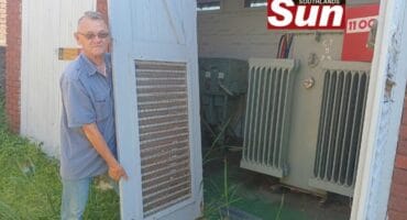 Ward 66 committee member for safety, security and health, Gary Vahl attempts to close a substation in Brighton Beach that is missing its lower hinges.