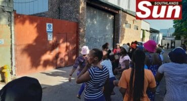 Workers and residnets protest outside a factory in Jacobs