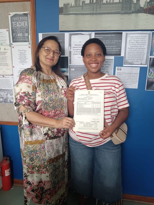 Principal of Wentworth Secondary, Laurel Cook congratulates Thembelihle Miya for obtaining six Distinctions.