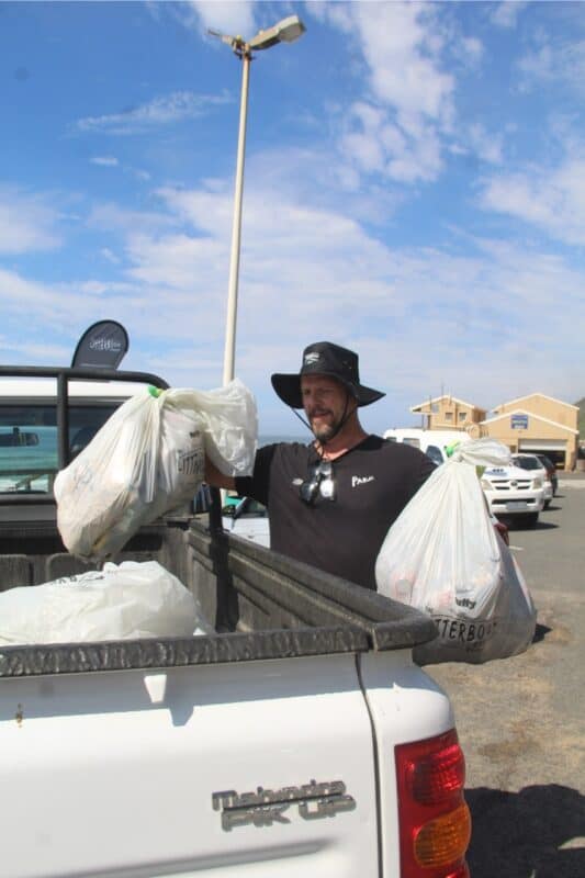 Evan Masson from The Litterboom Project loads the van with all the dirt.