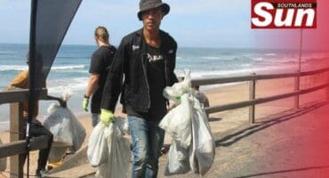 The Litterboom Project’s Mpilo Langelihle Mntambo clearing some of the dirt found at Brighton Beach.