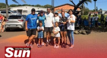 Lejeune Emmanuel celebrates crossing the finish line with her parents and her husband’s parents.