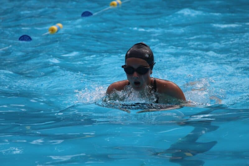 Neelah Brown from Grosvenor Girls takes a breath during the breaststroke. 