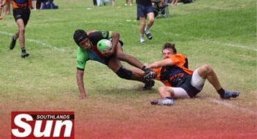Harlequins’ Tyrese Jacobs tries to get as close to the try line while the Amanzimtoti Rugby Club's player tries to drag him.