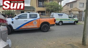 Police and private security companies gather outside a home where a pensioner's body was discovered.
