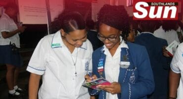 Cassie van Wyk and Hannah Dladla go through the pamphlets together.