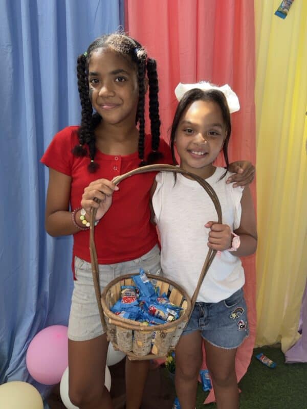 Amara Constable and Ziah Christian share a basket of Easter eggs.