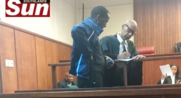 Advocate Ali Essop talks to his client, Mzomuhle Lawrence Gamede in court