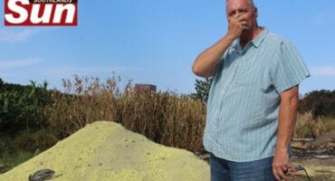 Ward 64 councilllor Norman Gilbert stands next to the suspended Sulphur chemicals dumped along Seaward Road near Clairwood