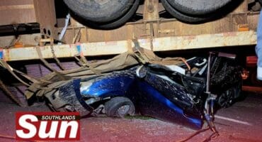 The heavy duty trucked overturned crushing the light motor vehicle.