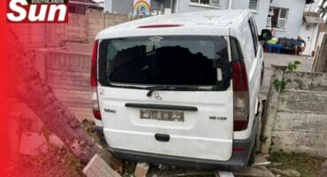 The vehicle reversed into the wall and wedged itself between the two properties.