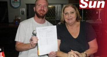 The duo of Phillip and Gillian Dix show off their quizzing card.