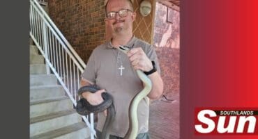 Warren Dick with the capture black mamba.
