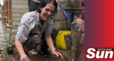 Tash Pretorius, scout leader cleans up outside the main hall during a previous renovation.