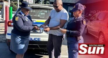 Members of the social crime prevention unit hand out pamphlets at Yellowwood Park SPAR.