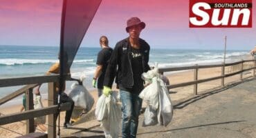 The Litterboom Project’s Mpilo Langelihle Mntambo clearing collected bags of dirt from Brighton Beach.