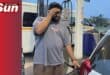 Dillon Pillay fills fuel in his car worriedly.